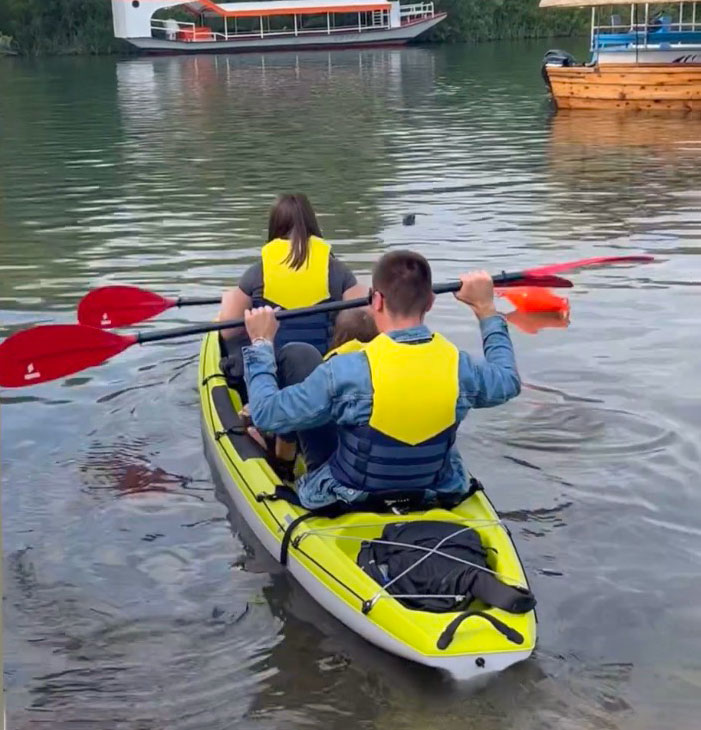 People paddle on kayak